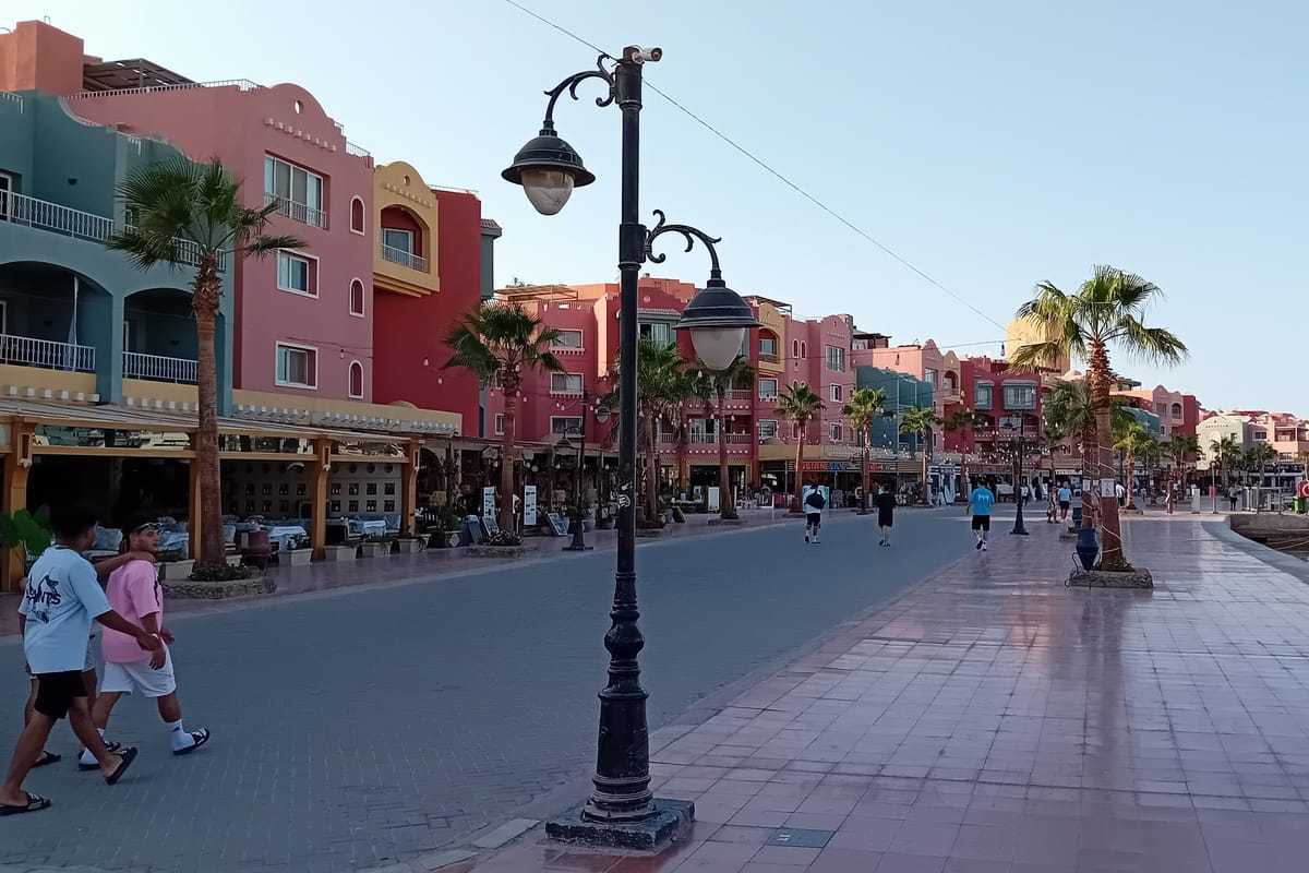 Promenáda v maríne v Hurghade s farebnými domami, palmami a lampami